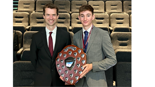 Zac Mooney pictured holding his award beside mentor John Lenehan