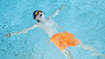 Boy practicing float technique in pool